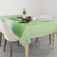 Green tablecloth covering a dining table with a skull-and-rose print centered.