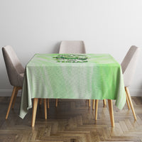 Green rectangular tablecloth with a centered skull-and-rose emblem across the top.
