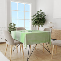 Green tablecloth on dining table featuring a centered skull-and-rose design.