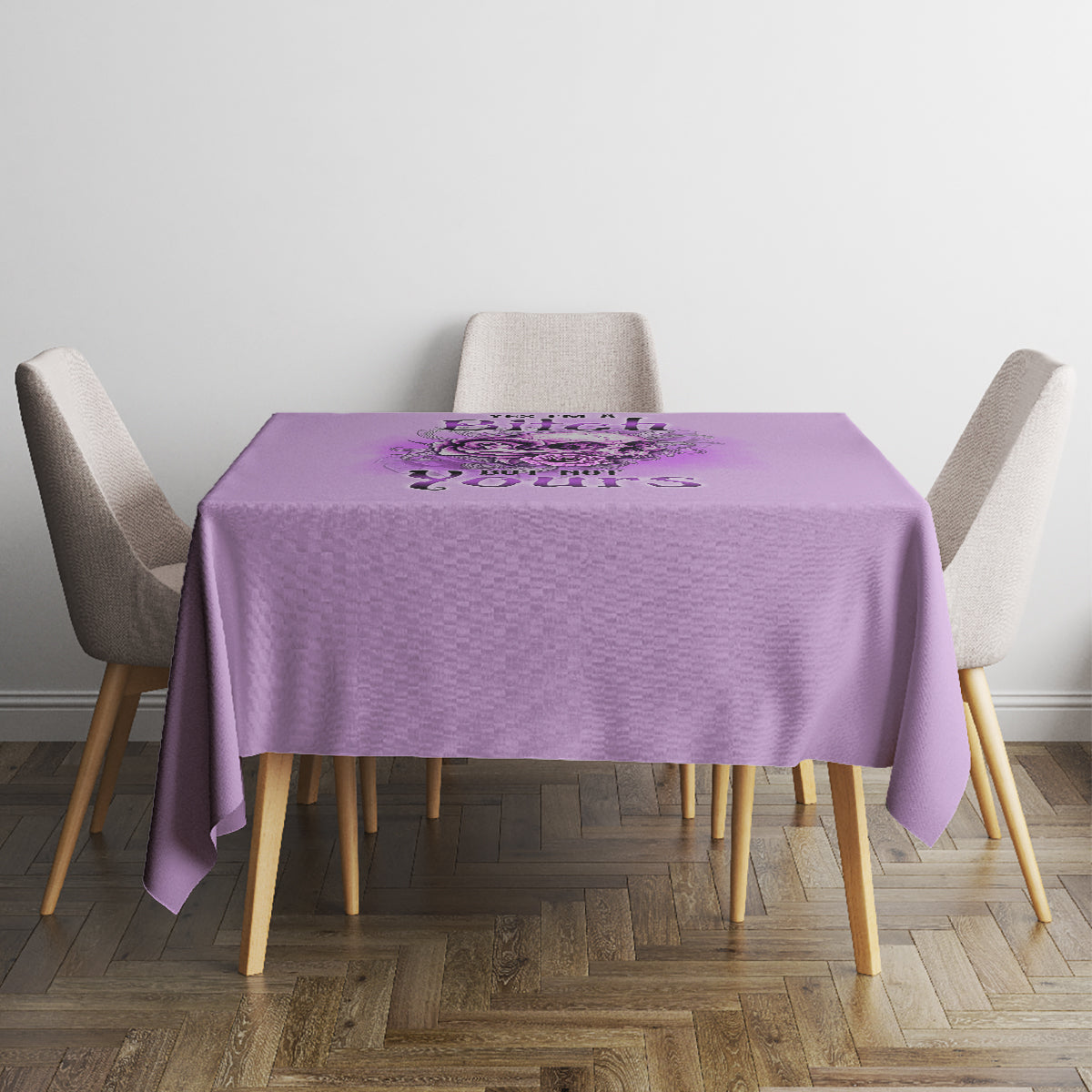 Purple printed tablecloth on small dining table with two chairs