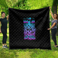 Black quilt with colorful skull and text graphic, diamond quilted pattern, stitched edges.