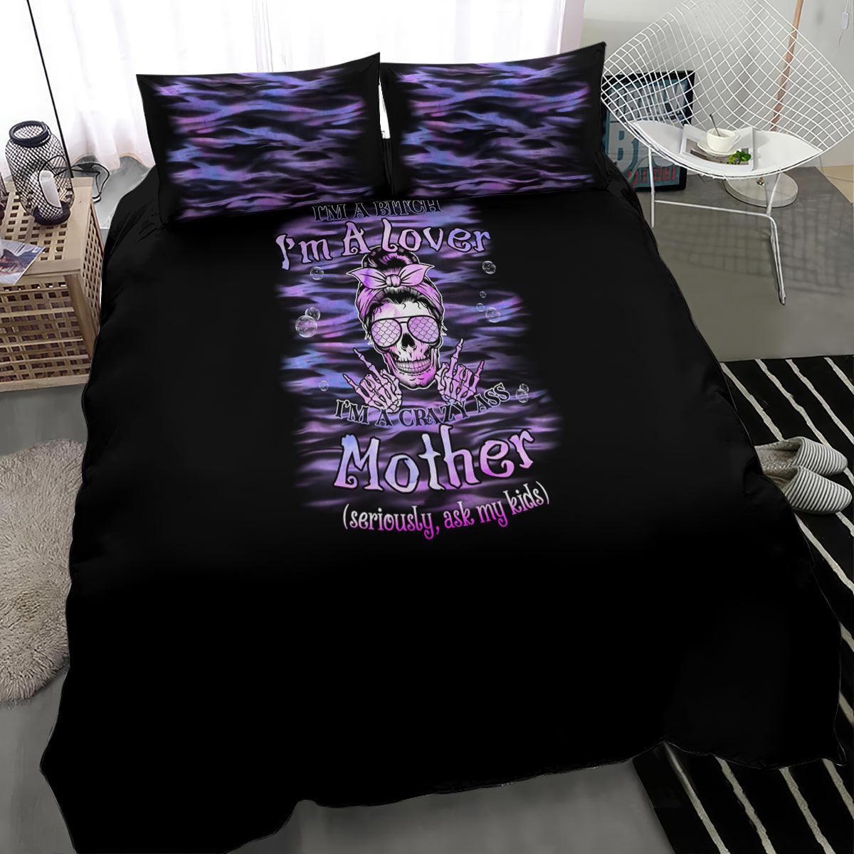 Black bedding set with purple skull-and-text center print and two matching pillowcases