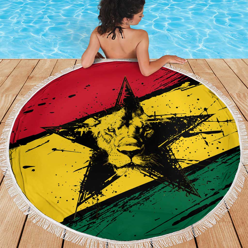 Round Ghana flag beach blanket with fringe, lion-and-star design on deck by swimming pool
