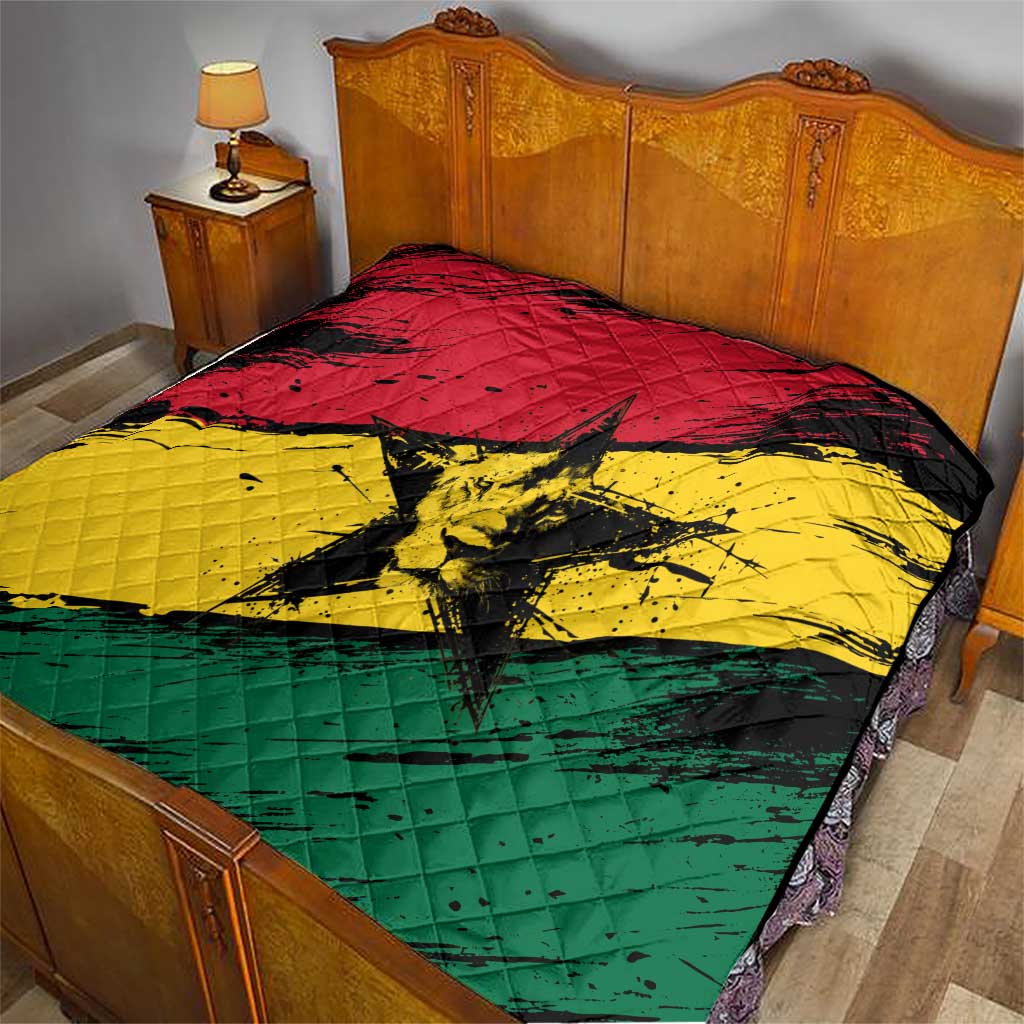 Ghana flag quilt with coat of arms star, spread across a bed in red yellow green