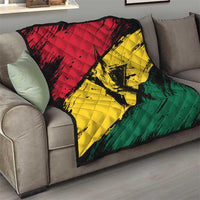 Ghana flag quilt with coat of arms star, folded over a sofa in red yellow green