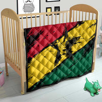 Ghana flag quilt with coat of arms star, laid across a baby crib in red yellow green