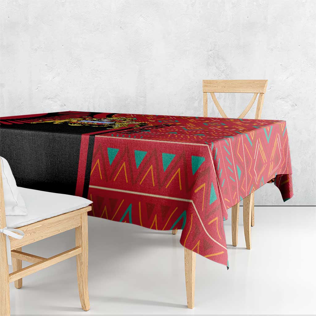 Rectangular tablecloth with red and black tribal-style geometric motifs on one corner