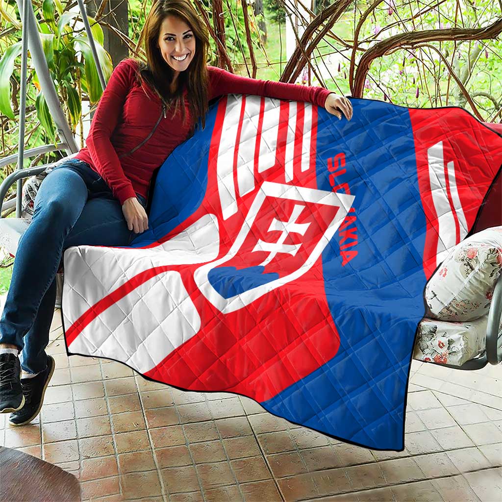 Slovakia flag quilt laid across seating, red, white, and blue diagonals with shield crest