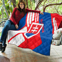 Slovakia flag quilt laid across seating, red, white, and blue diagonals with shield crest