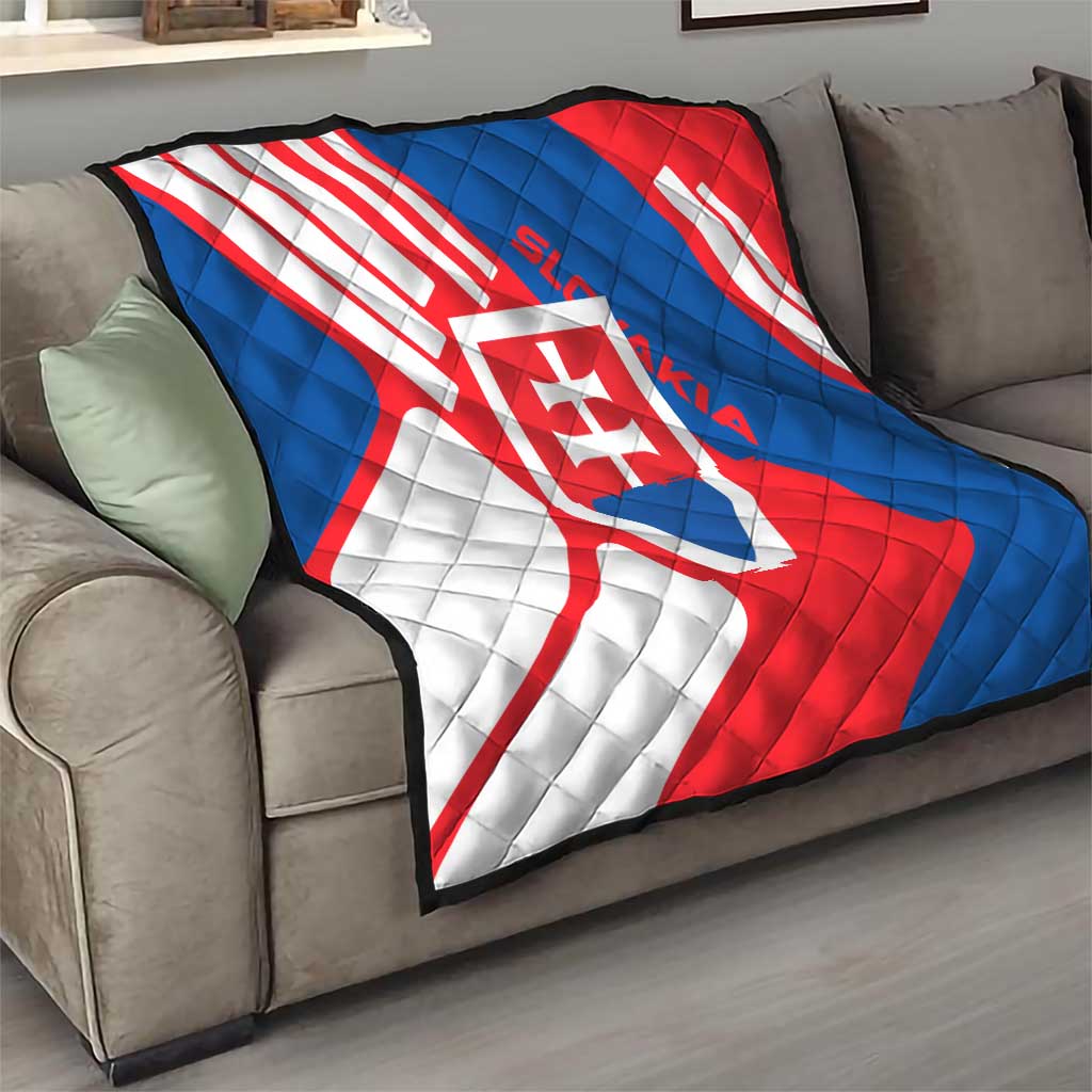 Slovakia flag quilt draped on couch, quilted red, white, and blue diagonal stripes and crest