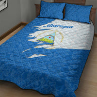 Quilt bed set featuring Nicaragua flag and emblem, blue-and-white quilt with two pillows