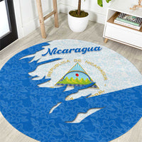 Round blue and light blue Nicaragua flag themed carpet with emblem and floral pattern