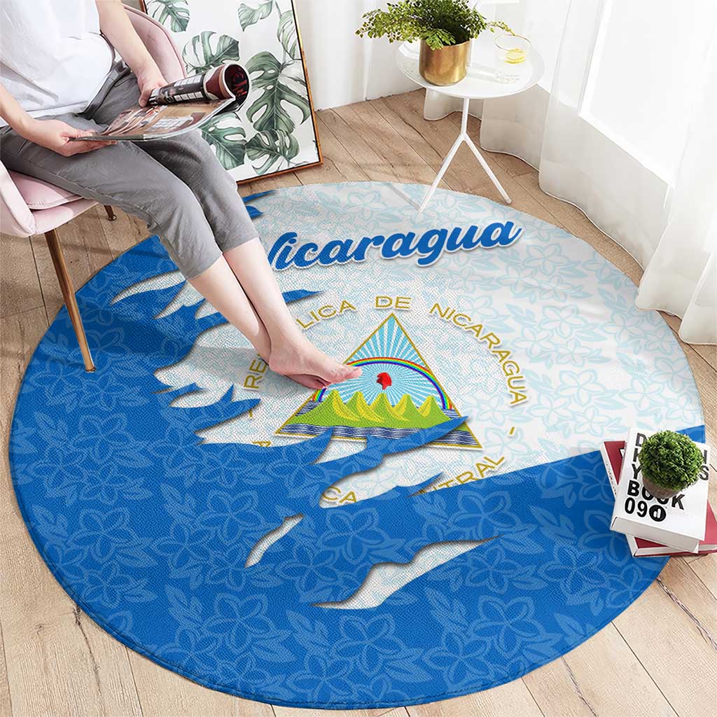Round carpet with Nicaragua flag ripped map look, national emblem, and floral pattern