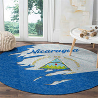 Round blue round carpet with Nicaragua flag emblem and ripped effect on floral design