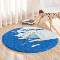 Round blue-and-light Nicaragua emblem carpet with torn-flag look and floral pattern