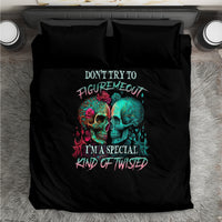 Black duvet and two pillows with colorful twin skull graphic and slogan, flat lay