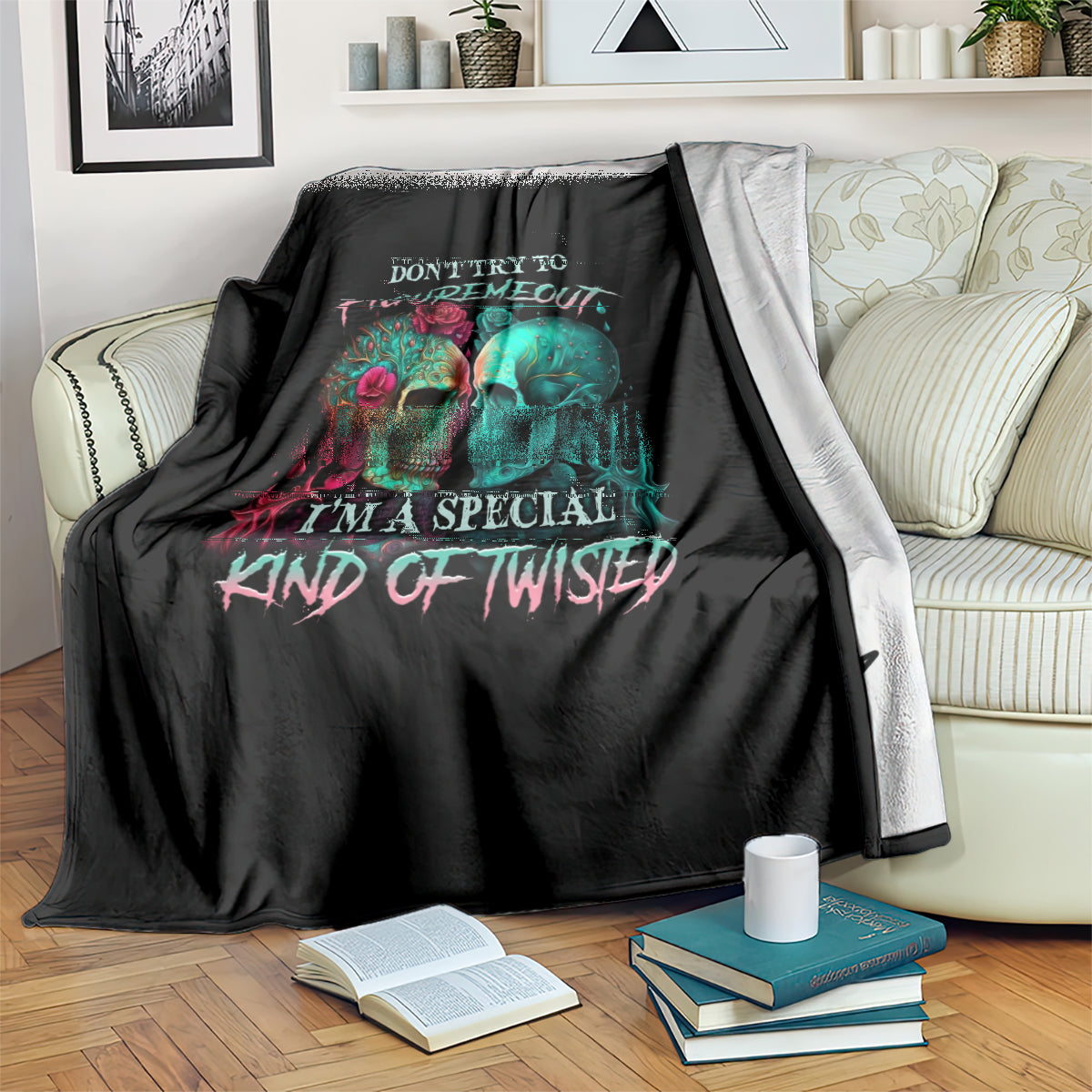Black skull blanket with multicolor twin skull graphic, draped with light gray reverse