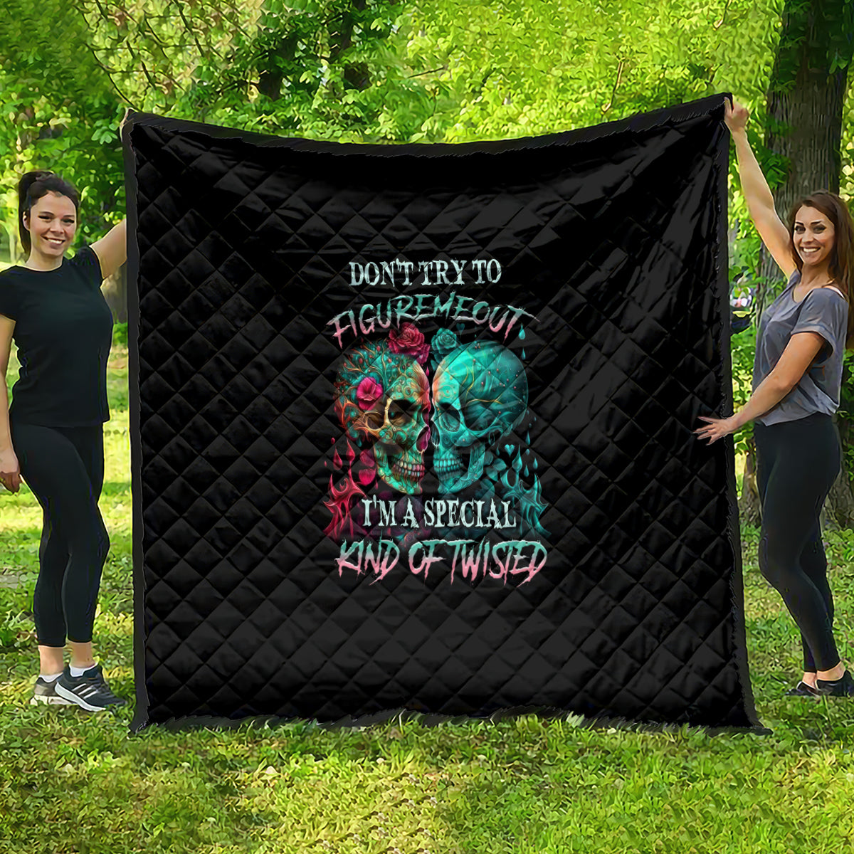 Black quilt with quilted diamond pattern and colorful twin skull graphic