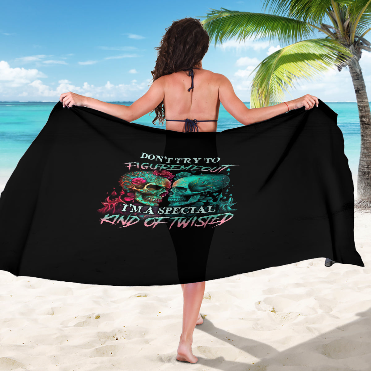 Black skull graphic sarong with colorful text, draped wide wrap.