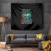 Black skull wall tapestry with multicolor text and two skull faces graphic.