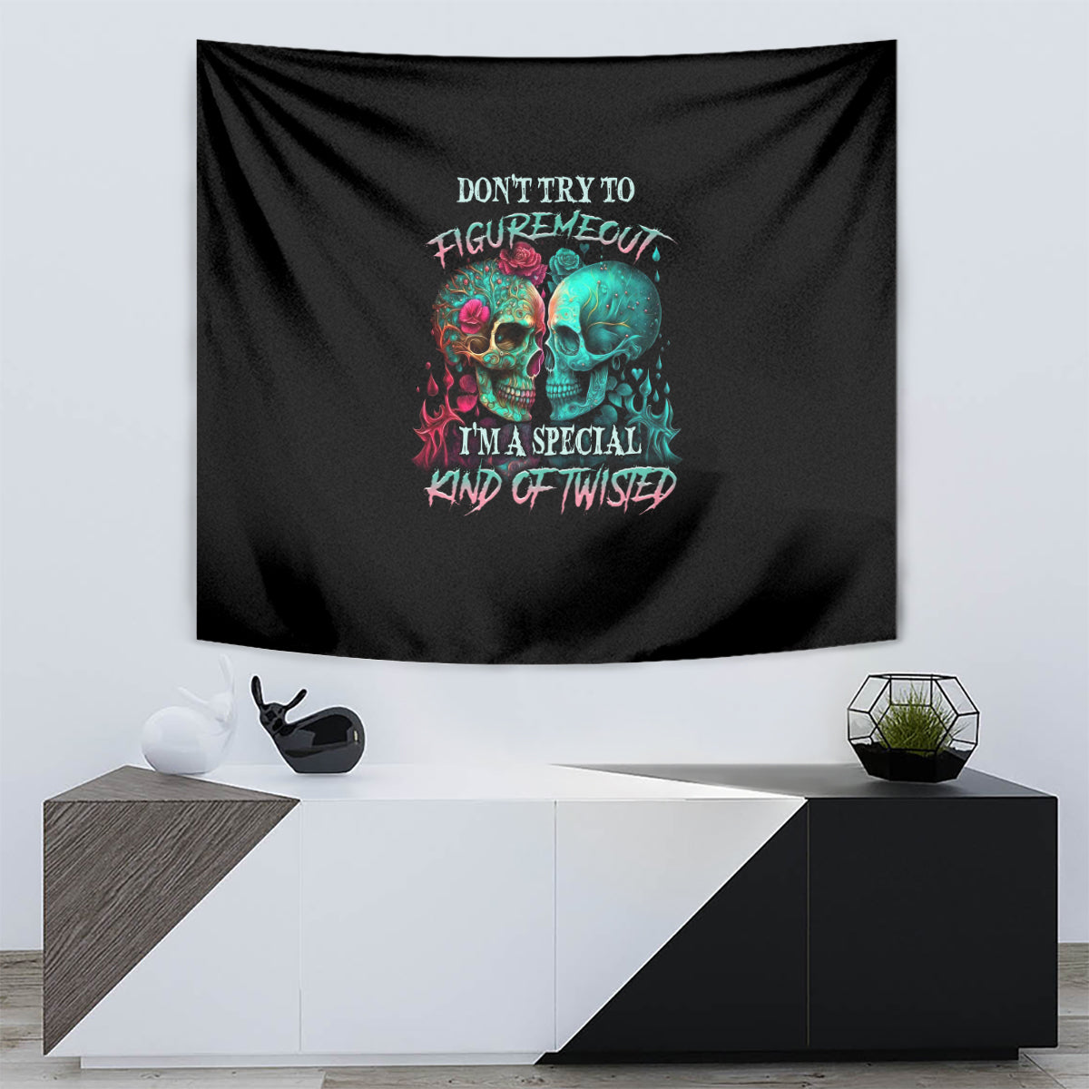 Black skull tapestry featuring multicolor text and two colorful skull faces.
