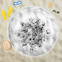 Round black-and-white printed beach blanket with fringe border and centered skull artwork