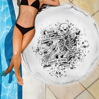 Round black-and-white printed beach blanket with fringed border, skull game graphic close-up