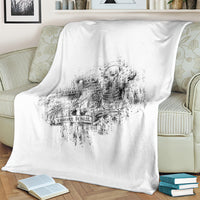 White throw blanket with faded black skeleton emblem across the middle panel