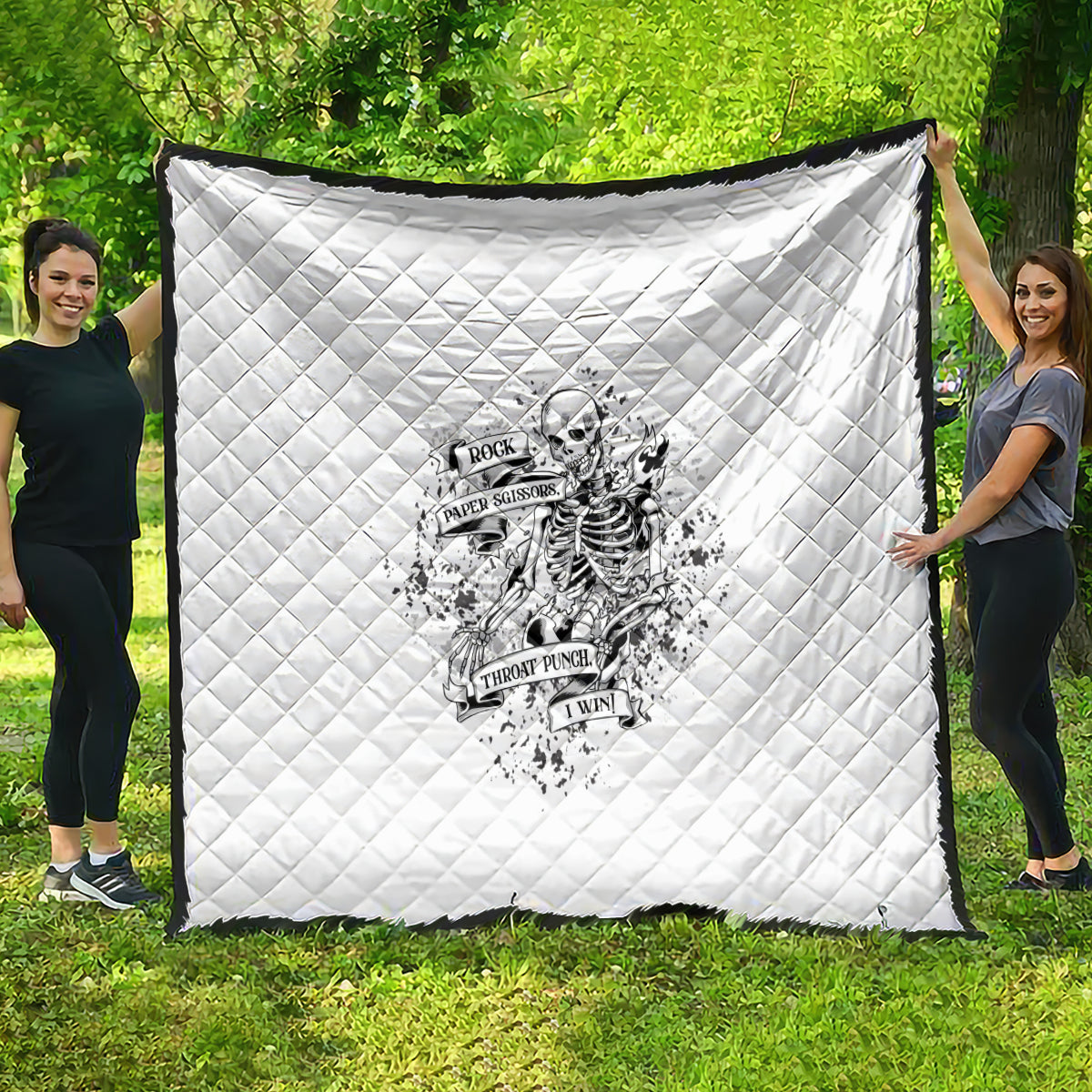 White quilt with diamond quilting and black-and-white skeleton graphic in the center