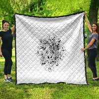 White quilt with diamond quilting and black-and-white skeleton graphic in the center