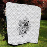 White quilt with stitched diamond pattern and black-and-white skeleton logo print