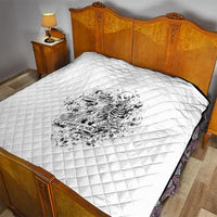 White quilted bed cover with diamond stitching and black-and-white skeleton graphic