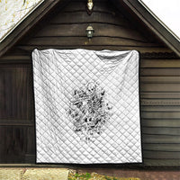 White quilt with dark-trim edges, diamond stitching, and black-and-white skeleton print