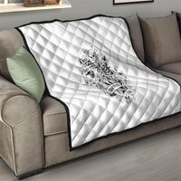 White quilt throw with diamond stitching and centered black-and-white skeleton artwork