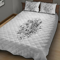 White quilt bed set with black piping; skeleton graphic on quilt and two matching pillows