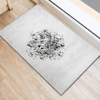 Black-and-white rubber doormat with skeleton rock-paper-scissors graphic and text