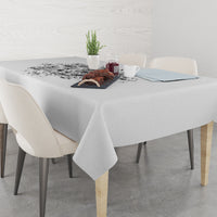 Black-and-white printed tablecloth neatly draped on a dining table with side dishes