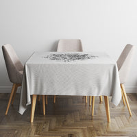 Black-and-white tablecloth with centered graphic print on a small round table