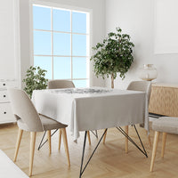 Black-and-white printed tablecloth on a rectangular dining table with four chairs