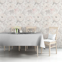 Black-and-white printed tablecloth on a dining table against a floral wall backdrop