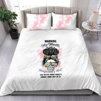 White bedding set with pink watercolor pillowcases and central illustrated warning text design