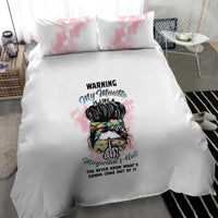 White bedding set with pink watercolor pillow shams and centered illustrated warning character