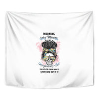 White wall tapestry close-up with multicolor character face and 'Warning' text