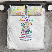 White bedding set with central sugar skull graphic and teal, yellow, pink swirl pillows