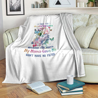 White throw blanket on couch with colorful sugar skull, butterflies, and quote text