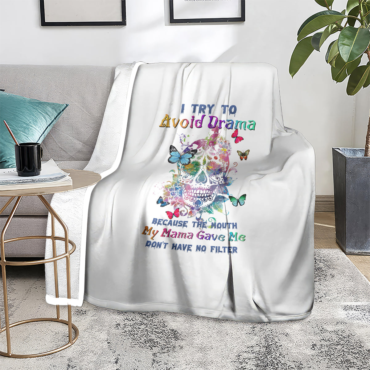White throw blanket on chair with colorful sugar skull, butterflies, and quote text