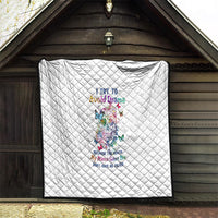 White quilt with diamond quilting and sugar skull print, displayed on outdoor wall