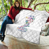 White quilt with diamond stitching and colorful sugar skull print, spread on outdoor seating
