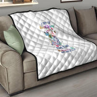 White quilt with diamond quilting and colorful sugar skull graphic over couch