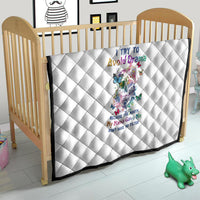 White quilt with diamond quilting and sugar skull artwork on crib